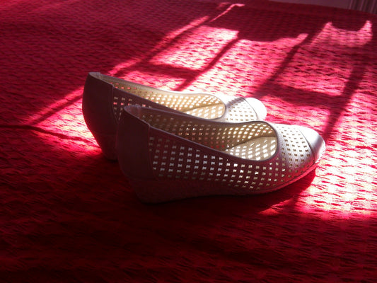 white and red flats on red textile
