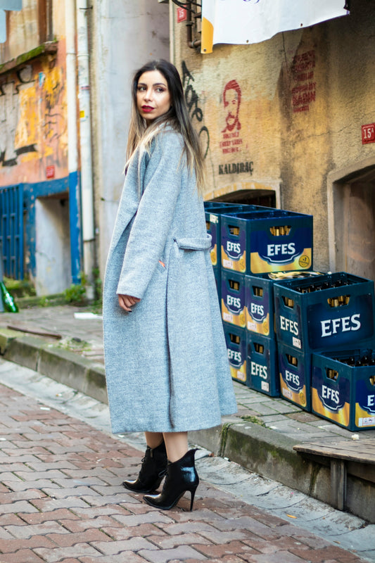 A woman is standing on a brick street