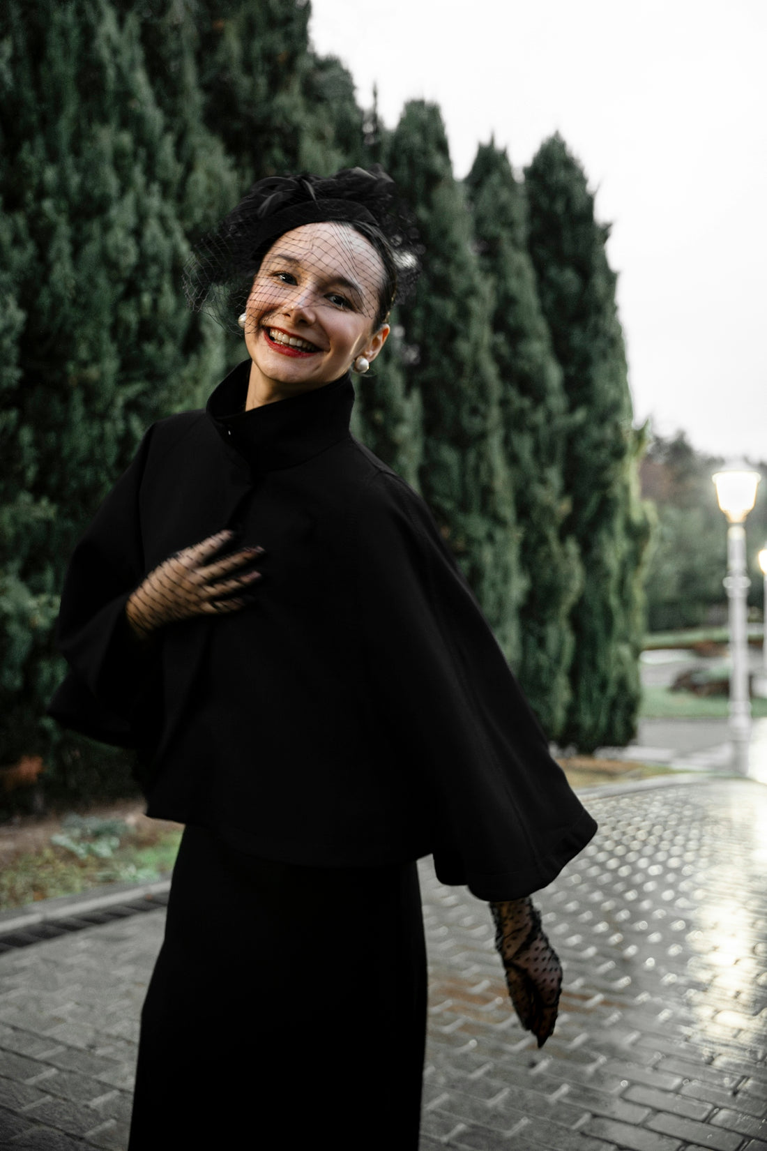 A woman in a black dress is smiling